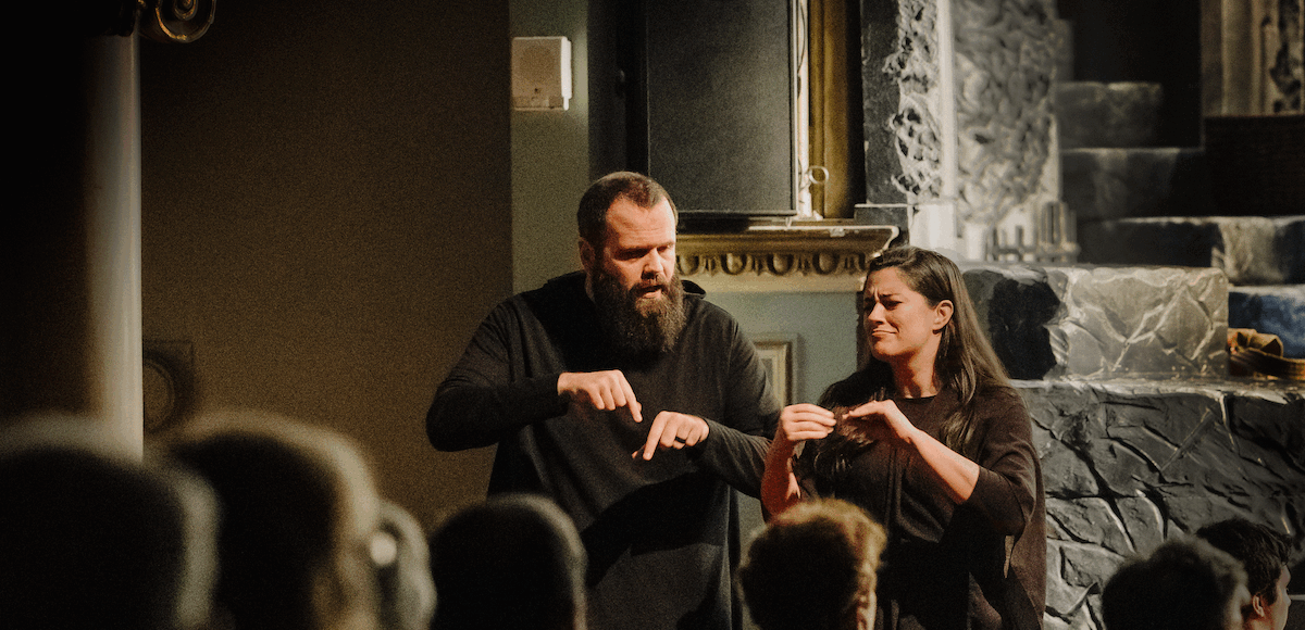 A man and woman providing American Sign Language interpretations of an Asolo Rep production.