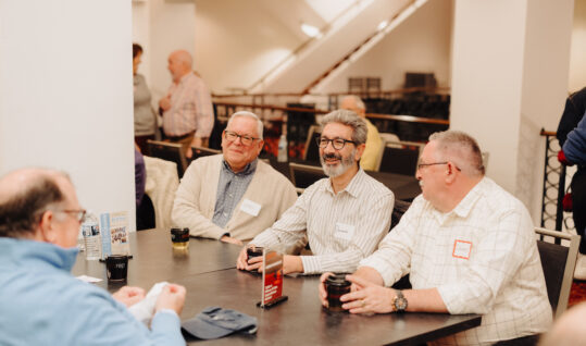 group of people sitting at a table at an event
