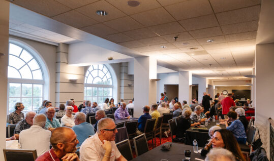 group of people sitting at a table at an event