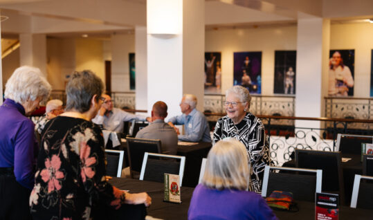group of people sitting at a table at an event