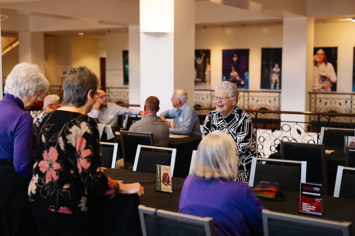 group of people sitting at a table at an event