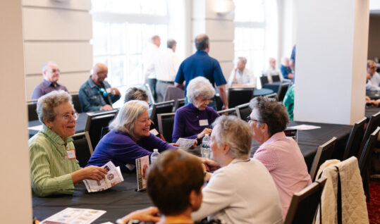 group of people sitting at a table at an event