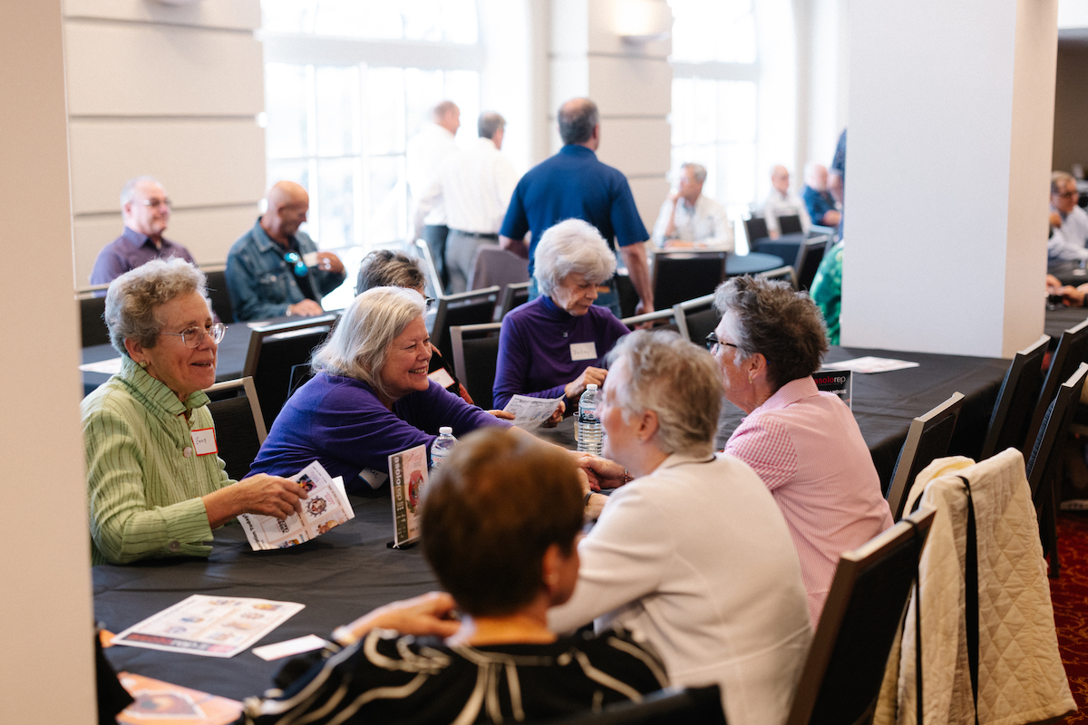 group of people sitting at a table at an event