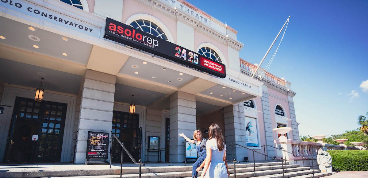 Two women walking up to the stairs to enter the Asolo Rep Theatre building.