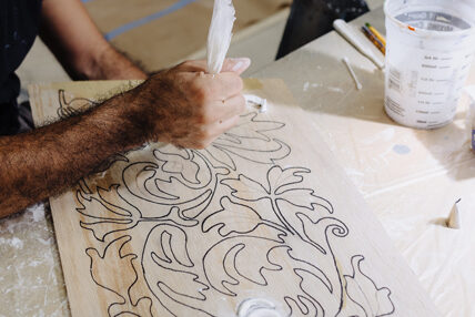 A man creating plaster detailing at Asolo Rep's Scenic Studio.