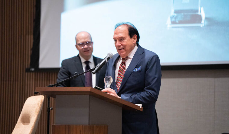 Two men standing on stage at a podium.