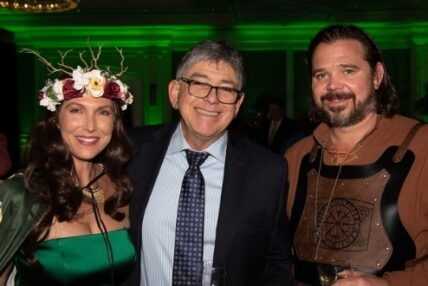 A costumed couple posing with a man in a suit at Asolo Rep's 2022 Annual Gala.