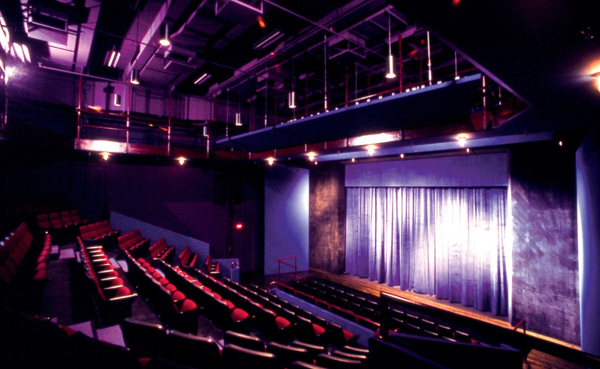 Theatre seats and a stage, both empty.
