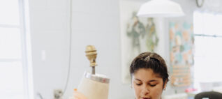 A teen camp participant examines a costume.
