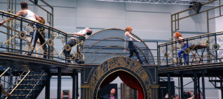 Actors rehearsing on a multi-tiered set