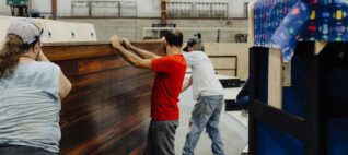 people working on building something in a shop